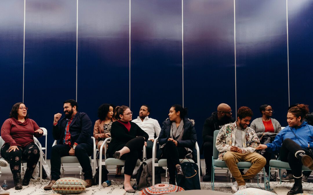 People sitting in a room talking together