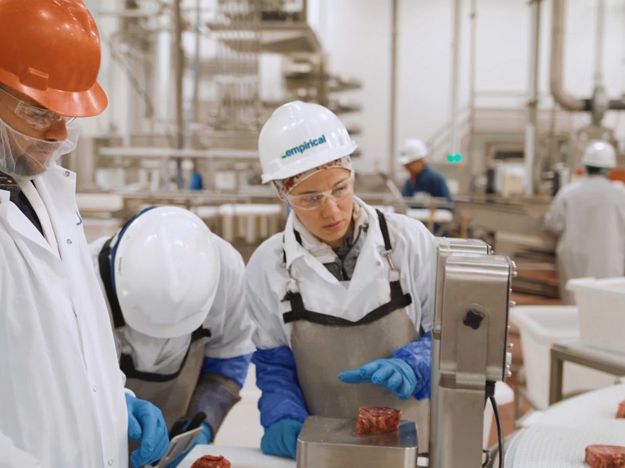 Woman working with a white hard hat and safety glasses on